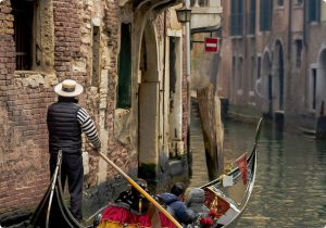 venice-canal-with-gondola-and-riders